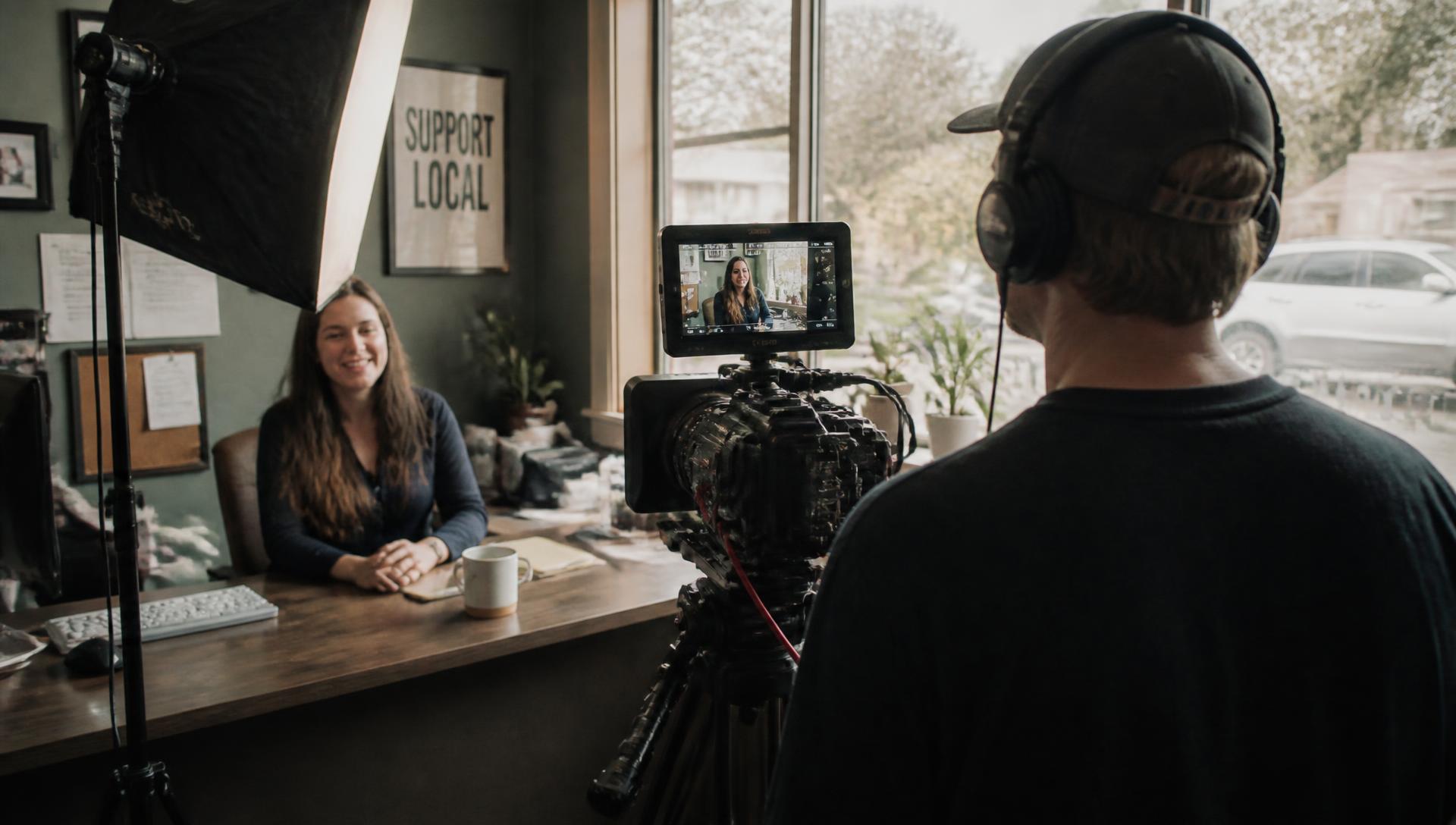 Videographer filming a local business owner on location in Houston